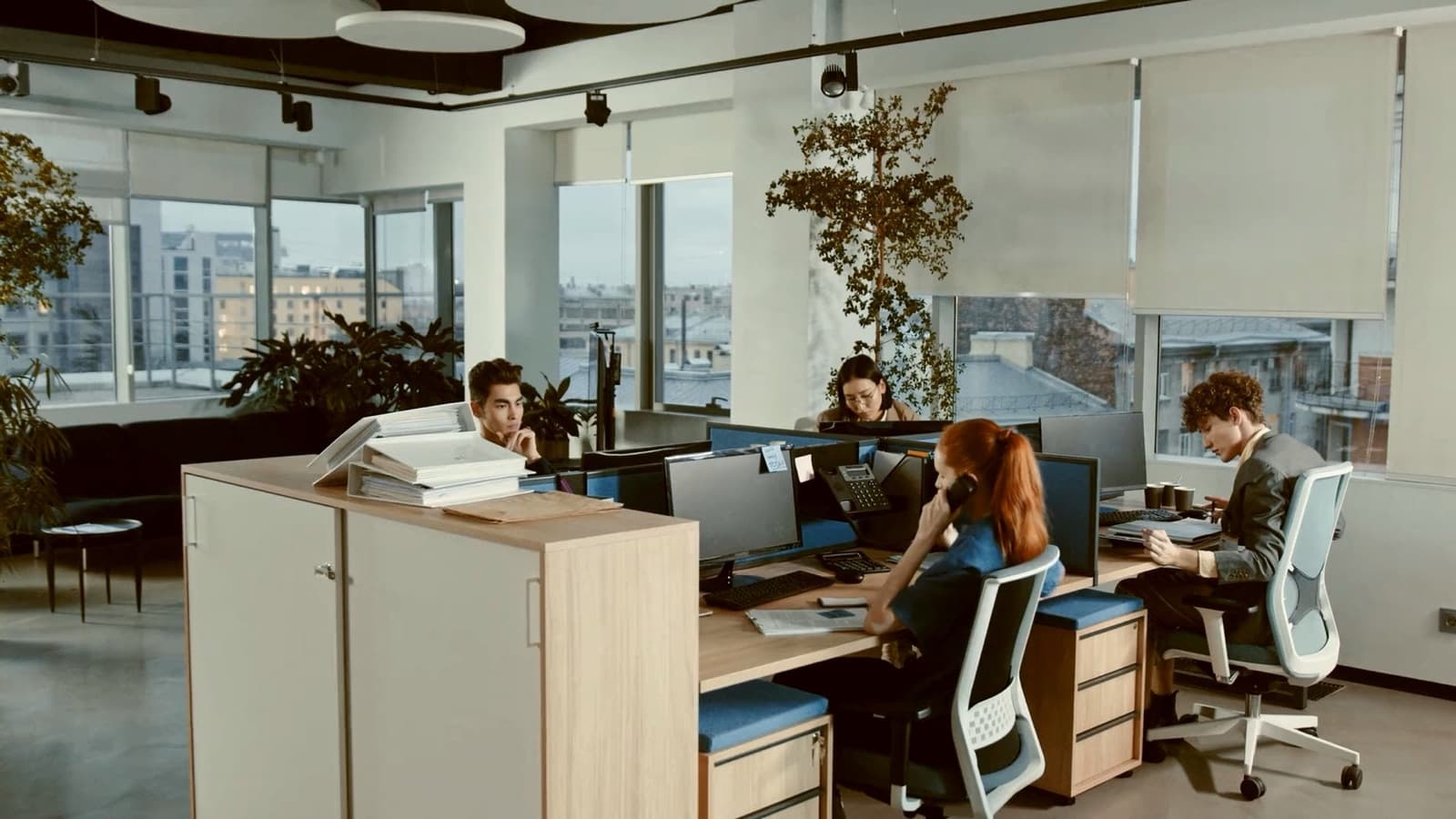 An open-plan office with people working at their desks