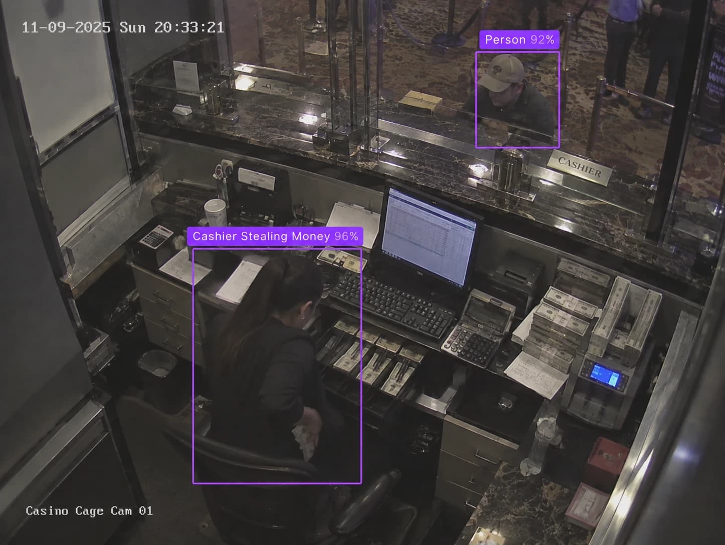 Cash cage camera: a cashier pocketing bills, boxed and labelled Cashier Stealing Money 96%
